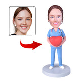 Female nurse holding red heart