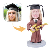 Female graduate is playing guitar