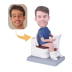 Man sitting on toilet reading newspaper custom bobblehead